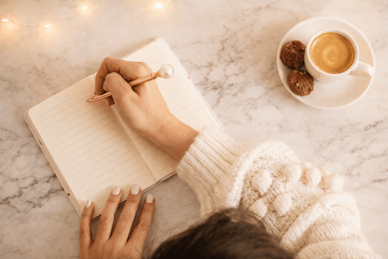 Woman journaling with coffee
